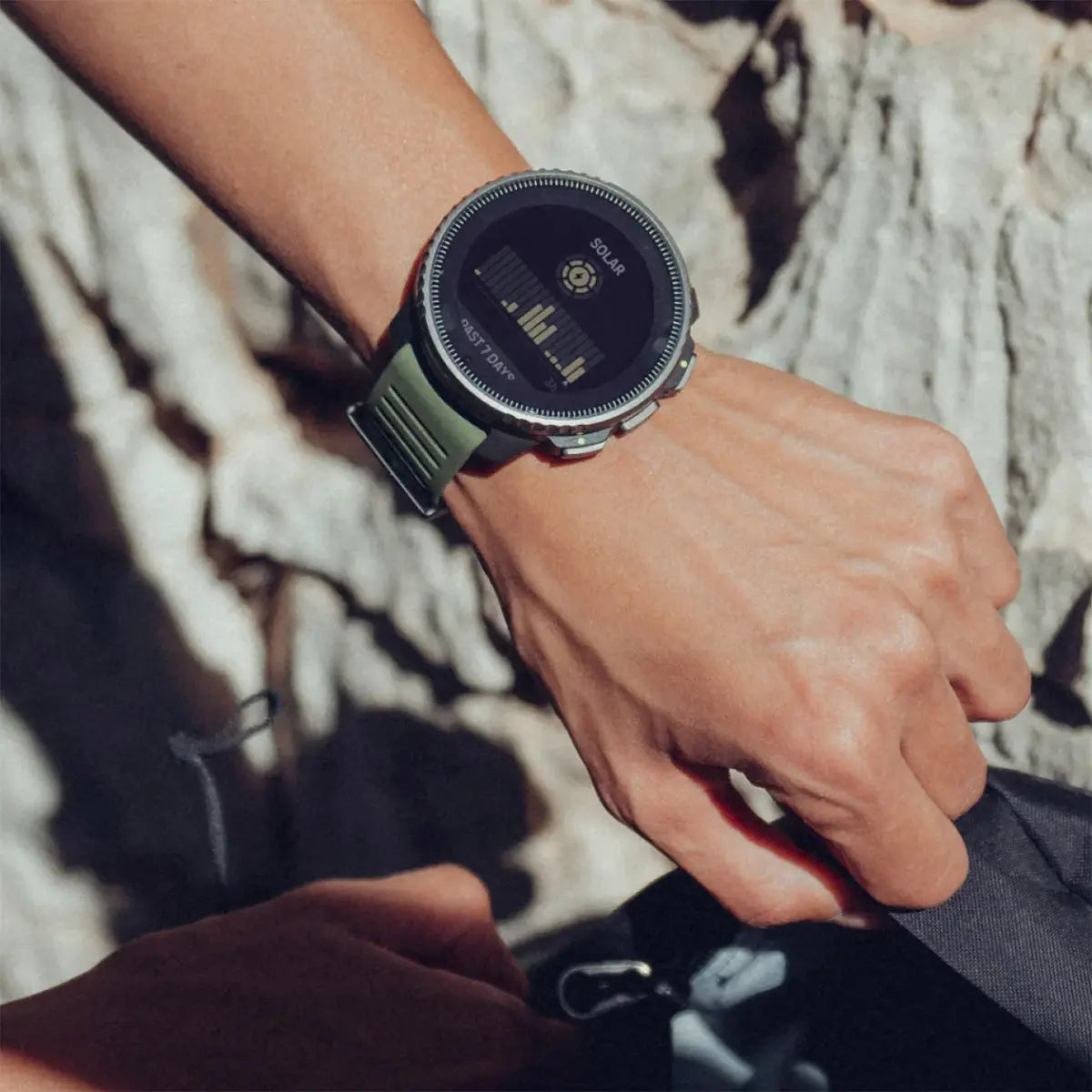 Suunto Vertical Solar GPS Smartwatch worn on a wrist, demonstrating its sleek design and real-time tracking features for outdoor activities.