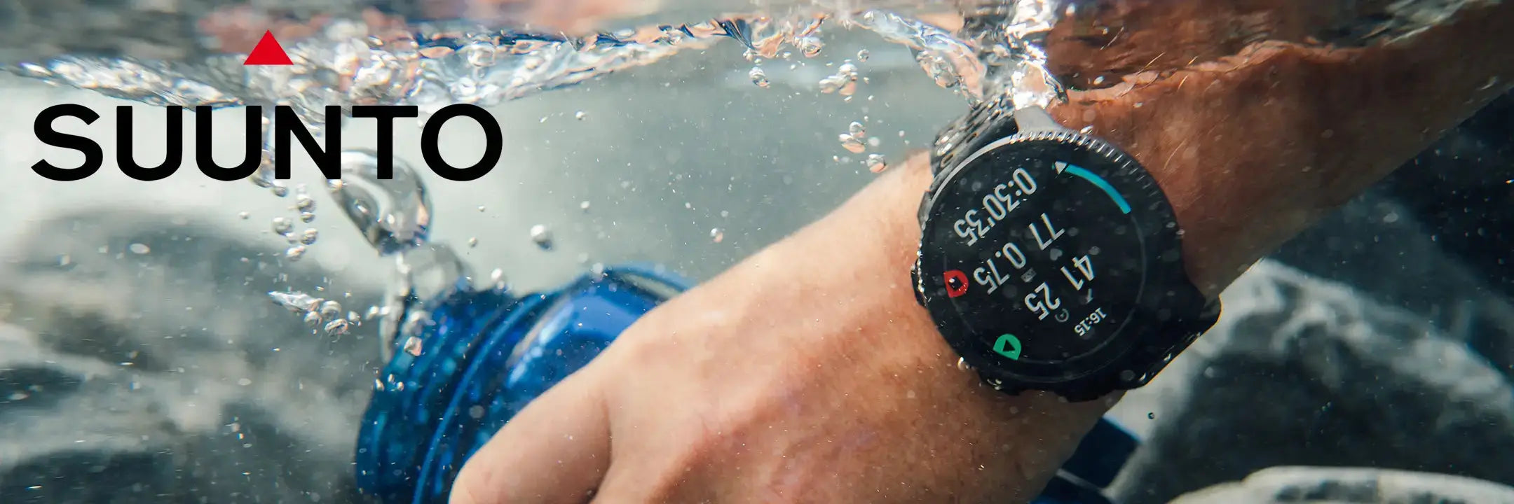 Person wearing a Suunto Vertical 2 watch underwater with water splashing around