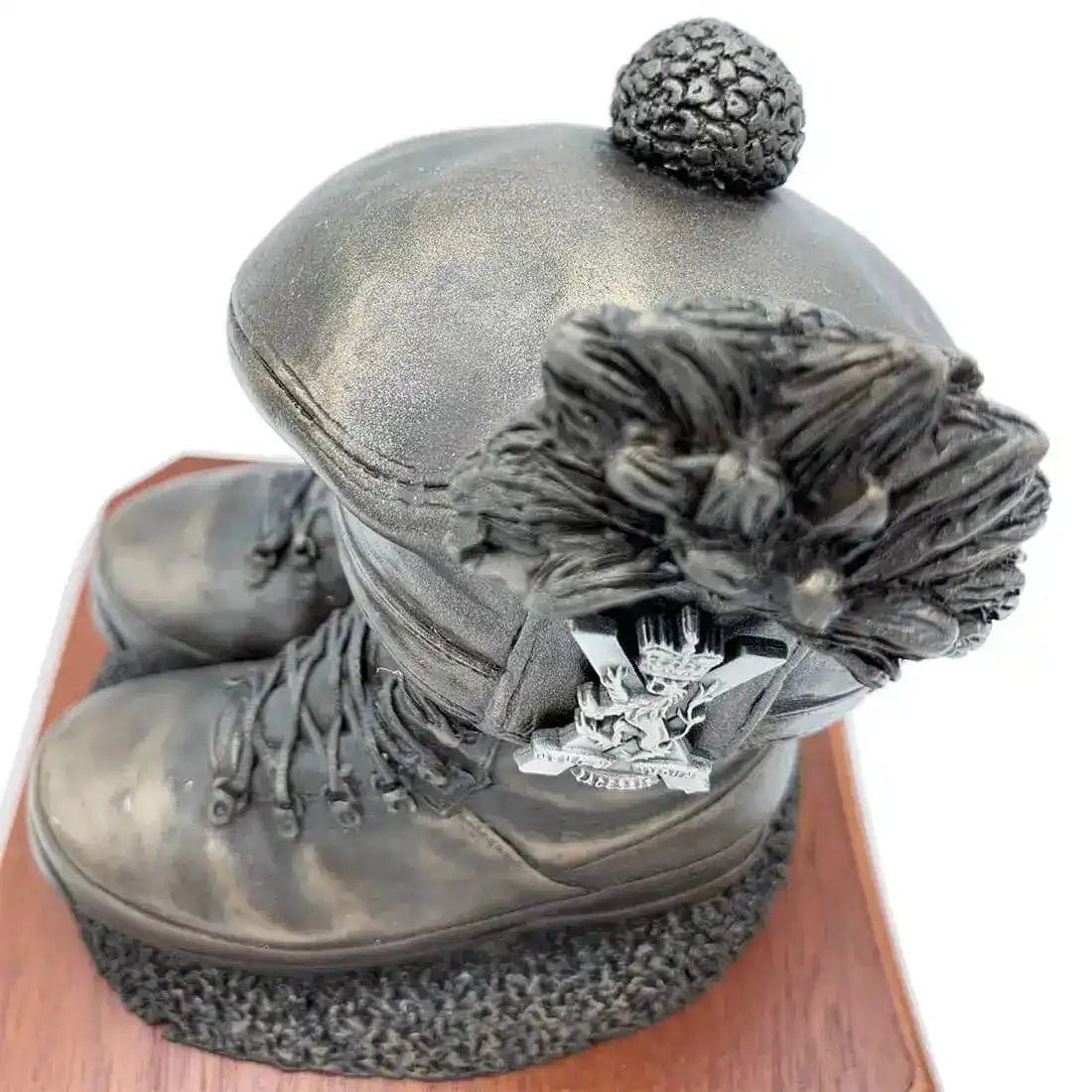 Close-up of Boots and Tam O'Shanter Statue with regimental badge detail on cap. Bronze resin sculpture honoring Scottish military heritage. from John Bull Clothing