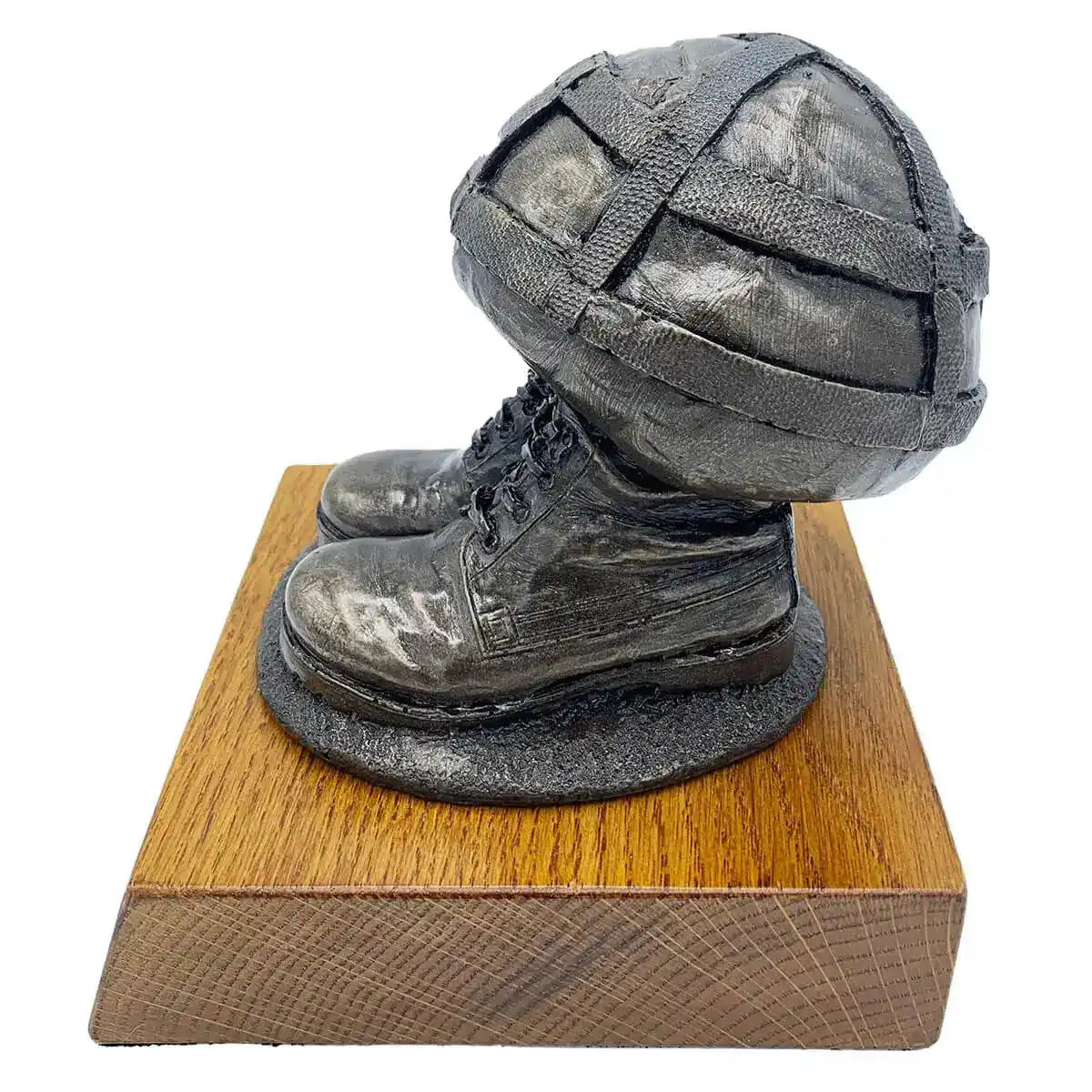 Side view of Helmet & Boots Bronze Resin Statue showing detailed army boots and helmet craftsmanship on oak-finished base. from John Bull Clothing