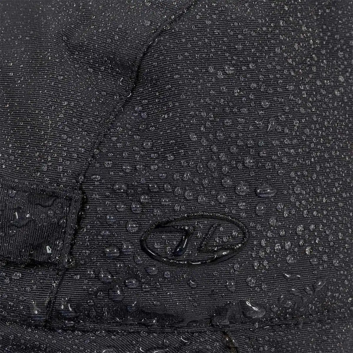 Close-up of water droplets on Highlander Dry Tech Mountain Waterproof Hat's Ab-Tex coated nylon fabric, showcasing waterproof performance. from John Bull Clothing