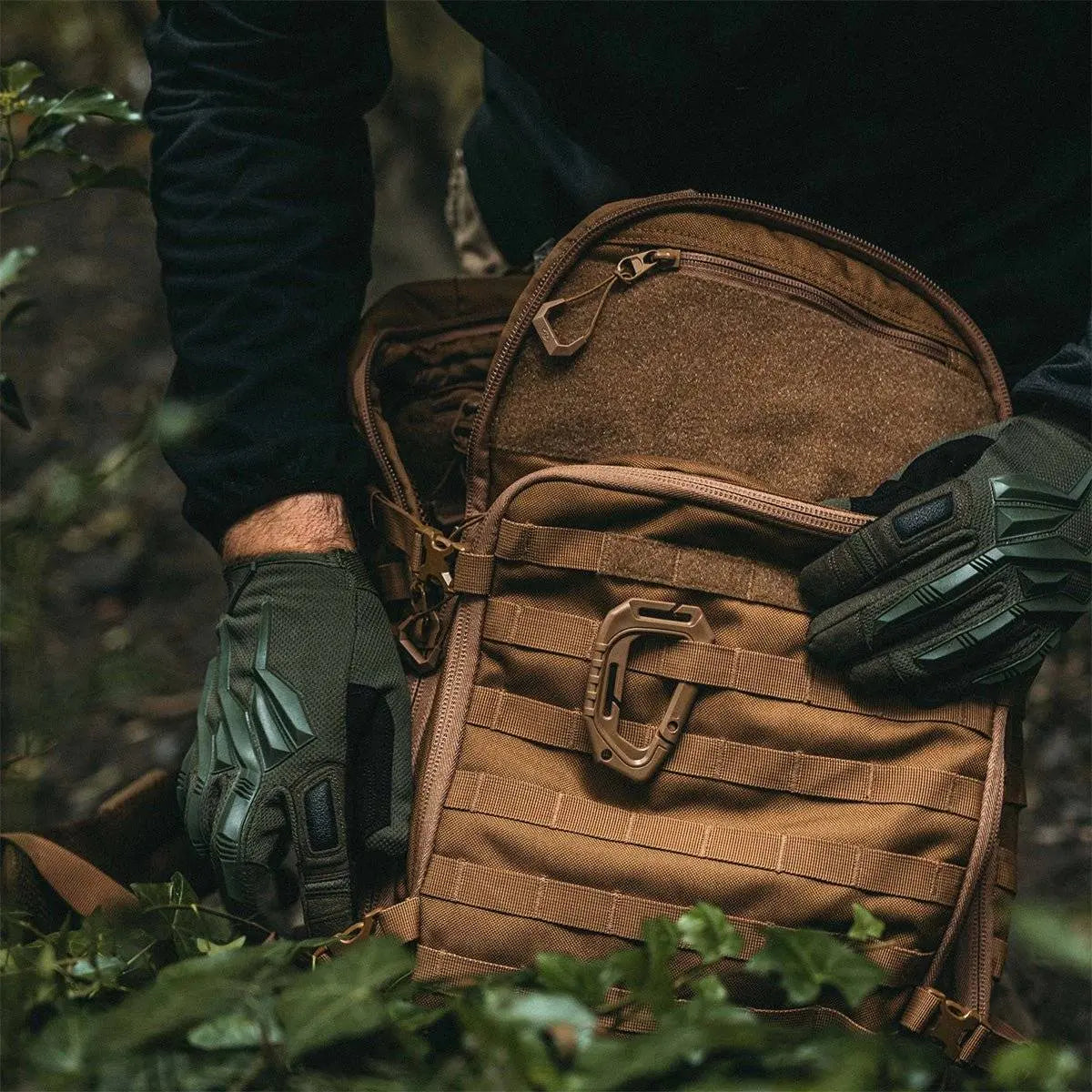 Close-up of Highlander Harrier 35L Full Clamshell Pack in tan, being used outdoors with tactical gloves, highlighting its rugged and functional design.
