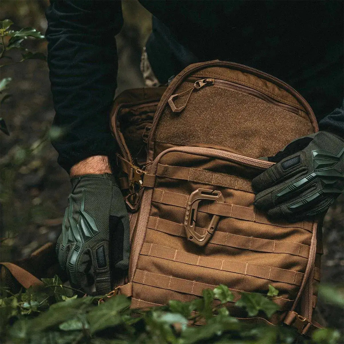 Close-up of Highlander Harrier 35L Full Clamshell Pack in tan, being used outdoors with tactical gloves, highlighting its rugged and functional design. from John Bull Clothing