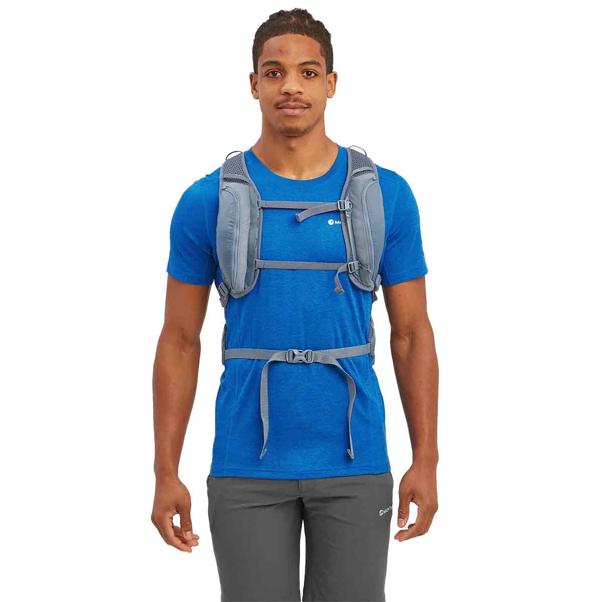 Front view of a man wearing the Montane Trailblazer 18L Backpack, showing adjustable chest straps for a secure fit.