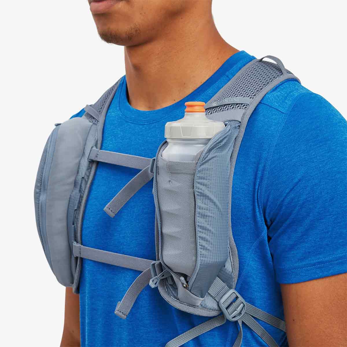 Montane Trailblazer 18L Backpack with a water bottle stored in the front pocket, emphasizing hydration accessibility.