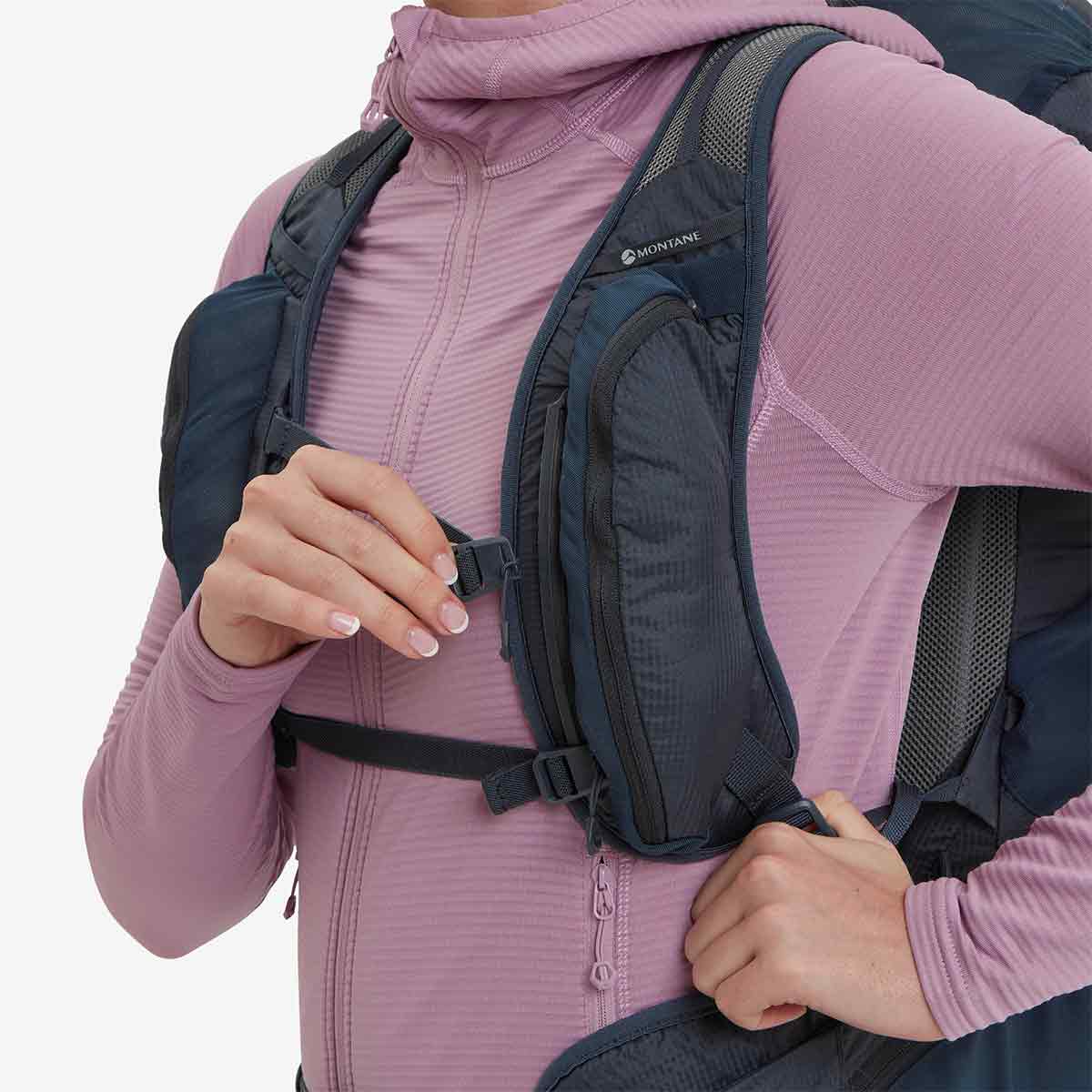 Close-up of Montane Trailblazer 24L Womens Rucksack chest strap adjustment, highlighting secure fit and front storage compartments for essentials.