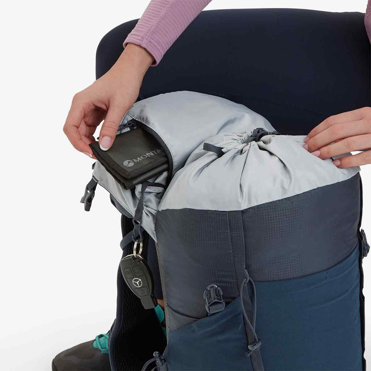 Top-loading Montane Trailblazer 24L Womens Rucksack with drawstring closure, internal storage compartments, and key clip for secure organization.