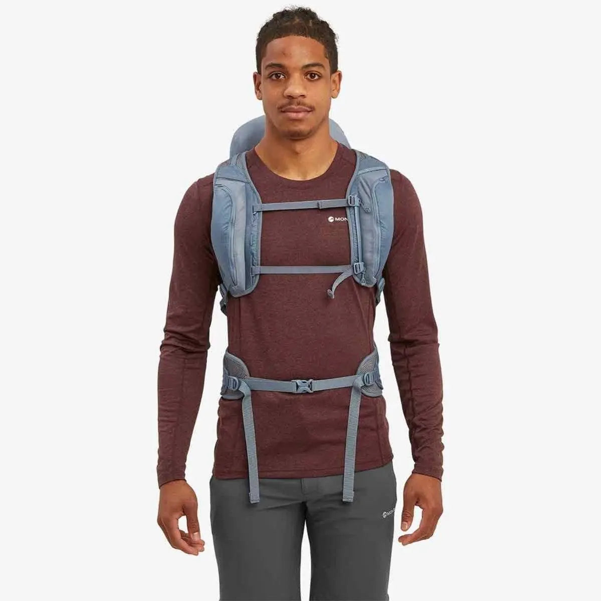 Model wearing the Montane Trailblazer 32 Litre Backpack in blue, highlighting the adjustable chest and waist straps for a secure and comfortable fit.