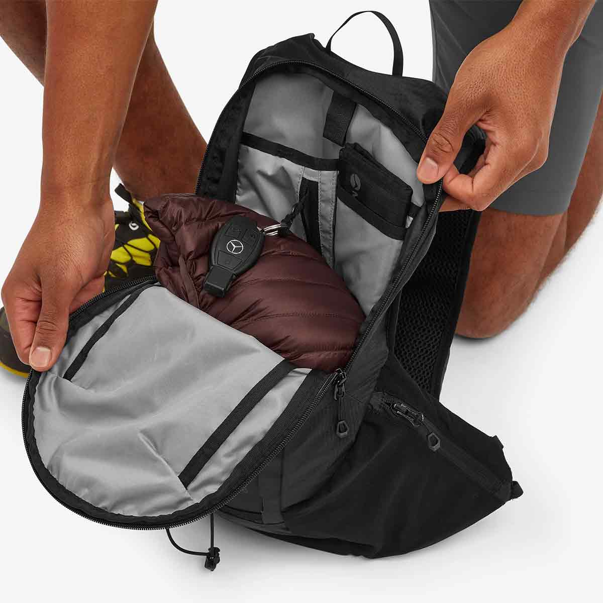 Open Montane Trailblazer 8L Recycled Backpack revealing spacious interior with organized compartments, ideal for carrying essentials during hiking and trail running.