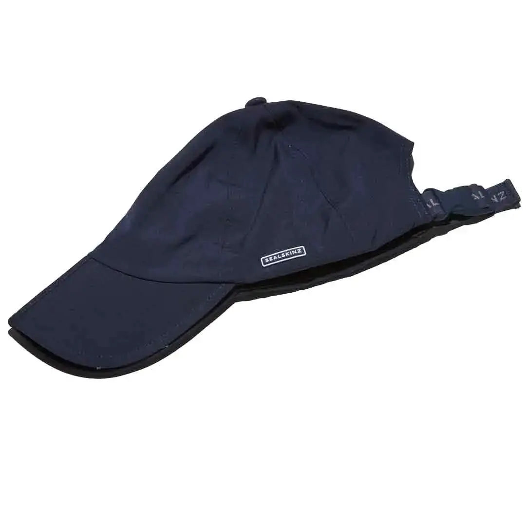 Folded navy Sealskinz Salle Waterproof Peak Cap showing adjustable strap and compact design for easy packing and portability. from John Bull Clothing