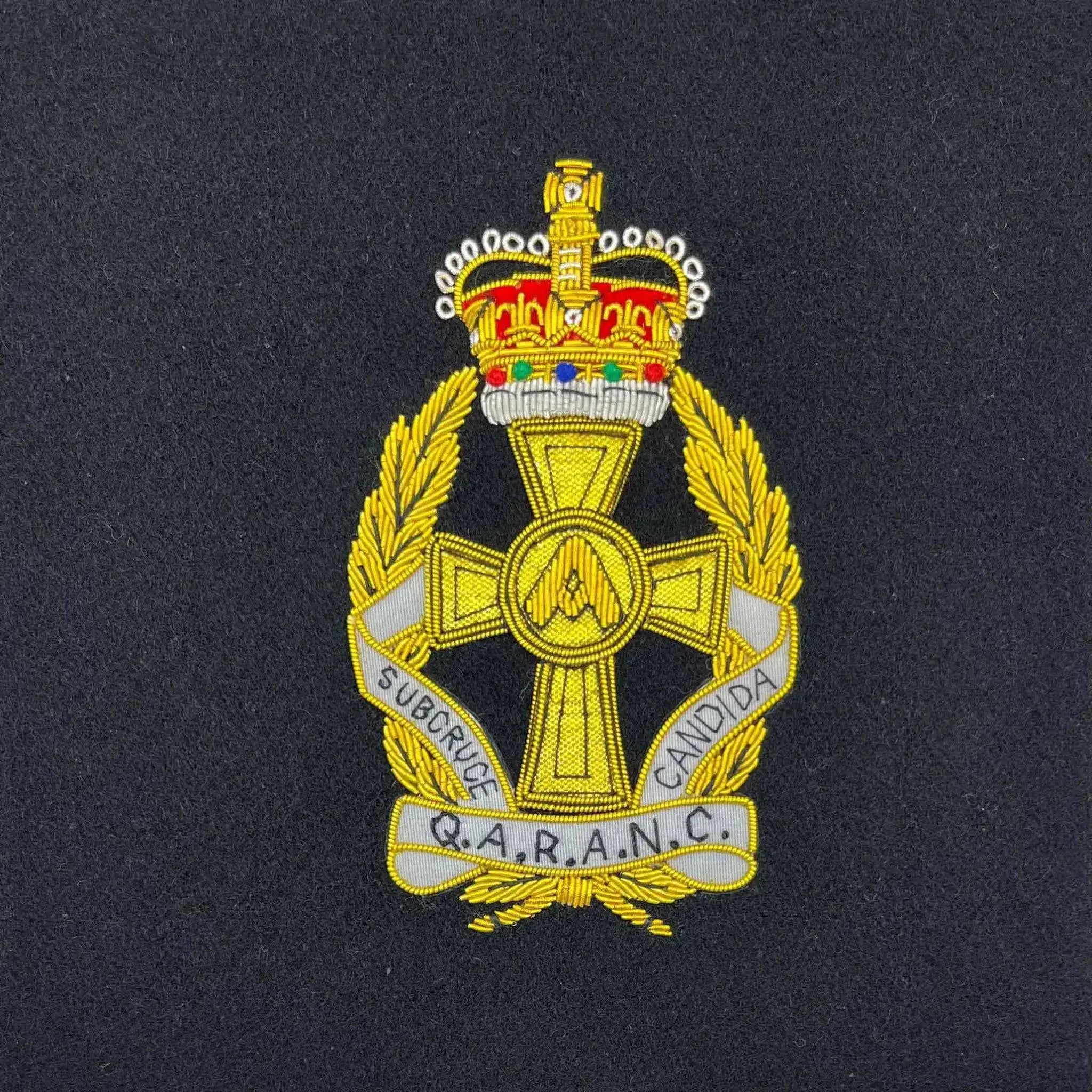 Embroidered Q.A.R.A.N.C. regiment badge with gold detailing and a crown emblem. Perfect for military presentation frames and memorabilia collections. QARANC from John Bull Clothing