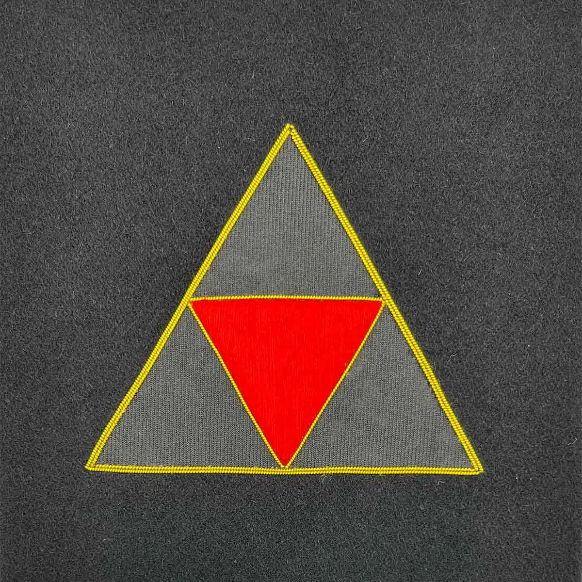 Triangular military insignia with a red and grey geometric design, bordered in gold. Suitable for framed Army presentations and military collections. 3 UK Division from John Bull Clothing