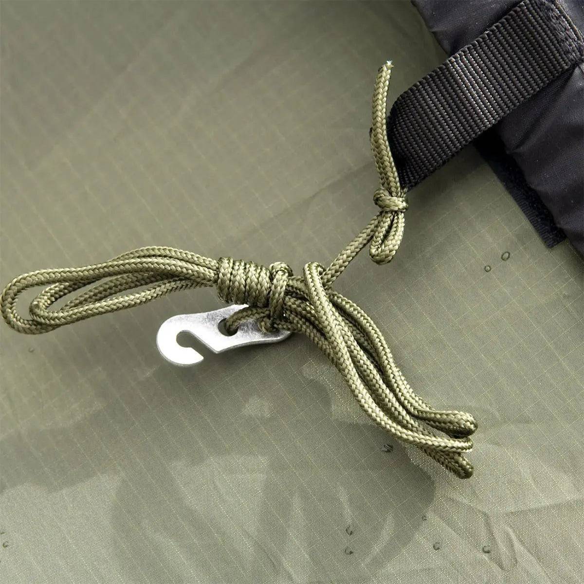 Detailed view of the Snugpak Scorpion 3 IX Hiking Tent's guy line and metal hook, ensuring secure anchoring in various weather conditions.