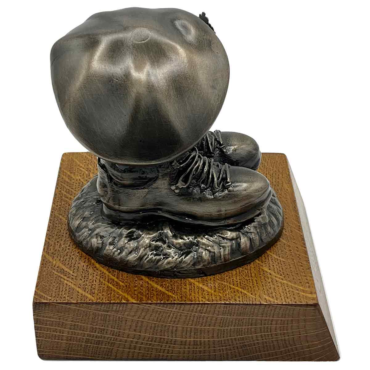 Angled back view of Beret and Boots Statue Bronze Resin on Oak Base | John Bulls, showing sculpted boot heels and beret folds.