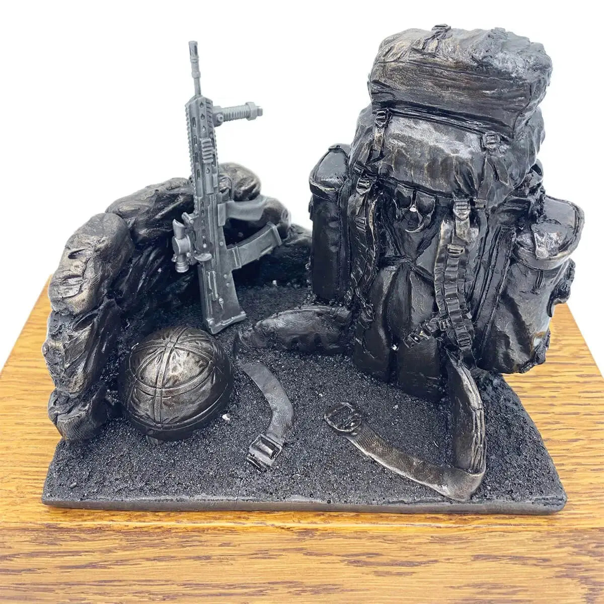 Top view of Bergen and SA80 bronze resin army statue showing helmet, rifle, and backpack on oak base, perfect for military gift or tribute.
