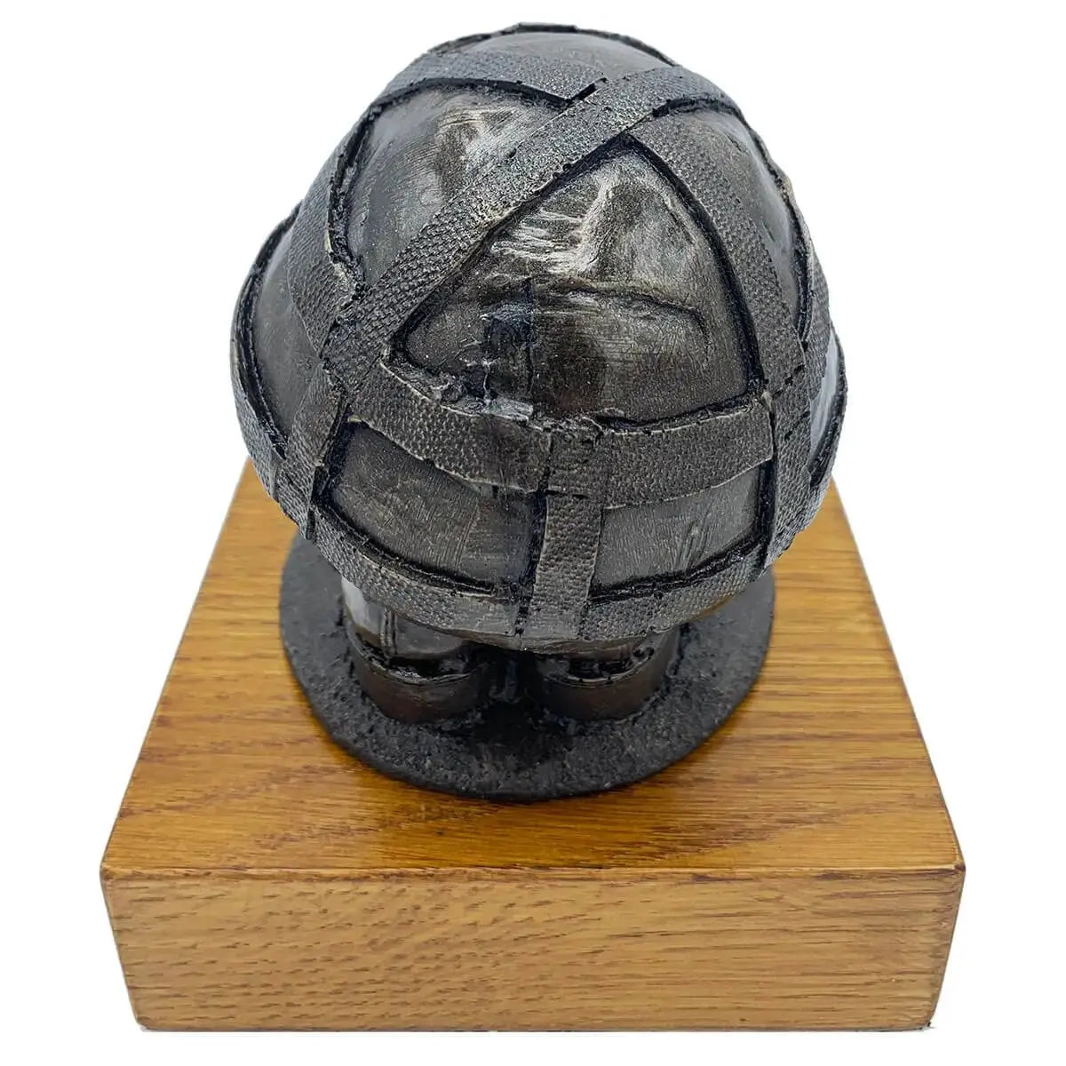 Rear view of Helmet & Boots Statue Bronze Resin | John Bull Clothing, showcasing helmet texture and resin finish on wooden platform.