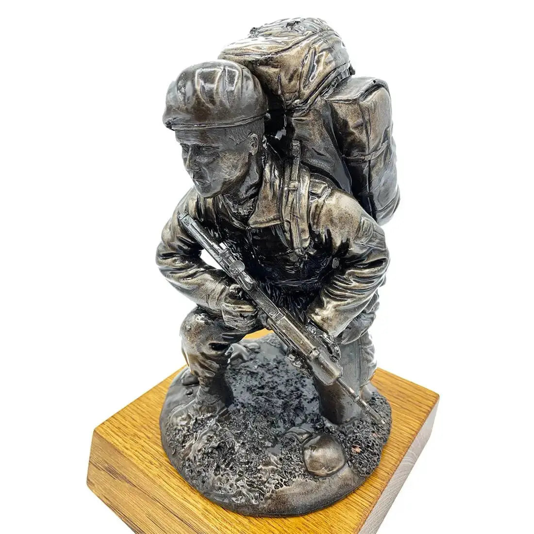 Angled top view of Kneeling Combat Figure with Beret Bronze Statue by John Bulls, highlighting lifelike resin craftsmanship and oak base support.