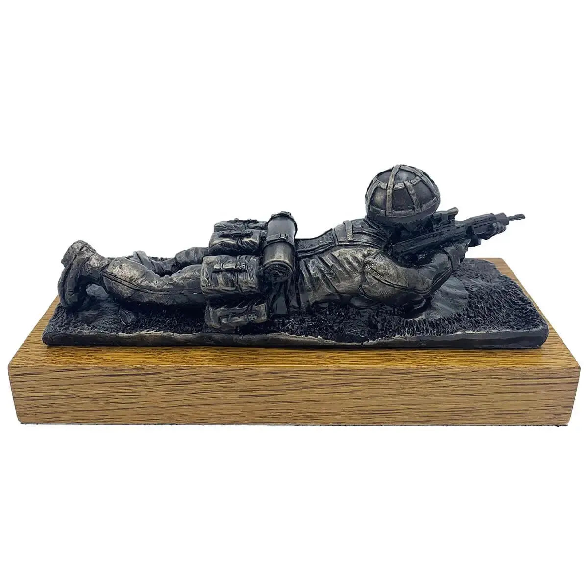 Bronze resin sculpture of a soldier in prone position with SA80 rifle, mounted on oak base, perfect for military collectors.