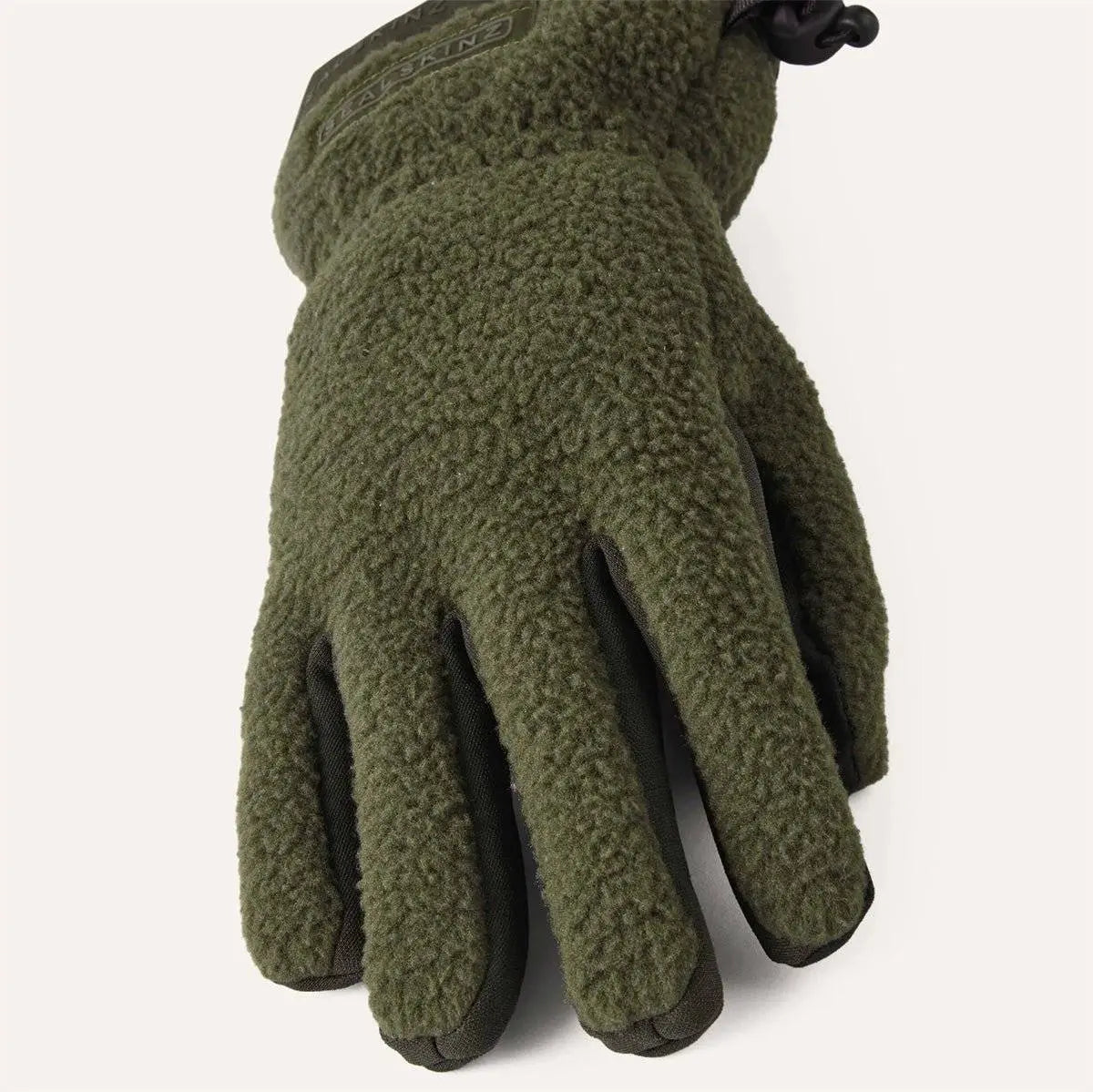 Angled view of green Sealskinz Hoveton Waterproof Sherpa Fleece Glove highlighting plush fleece texture and ergonomic design.