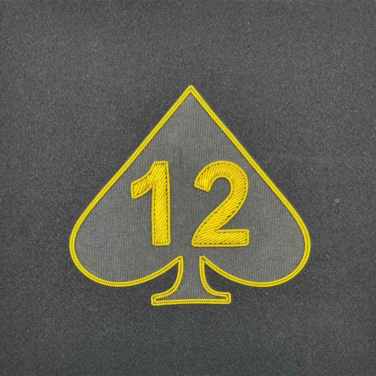 Spade-shaped military insignia with the number 12 in gold embroidery. Ideal for Army presentation frames and military memorabilia displays.