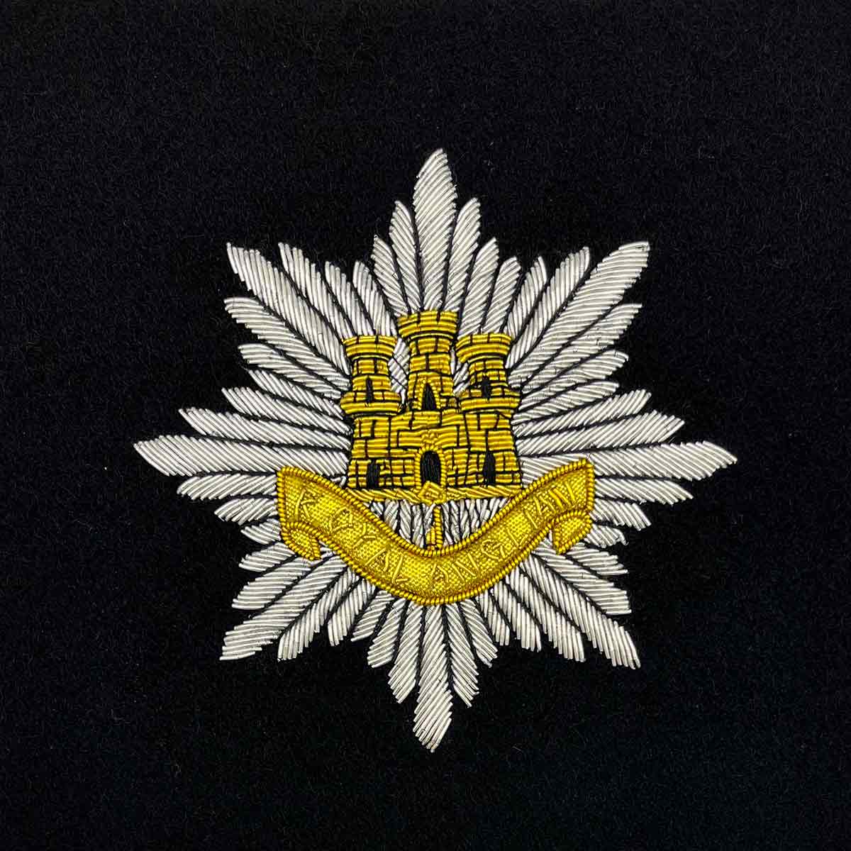 Royal Army Service Corps embroidered badge with a gold castle emblem on a silver starburst background. Suitable for framed military presentations.