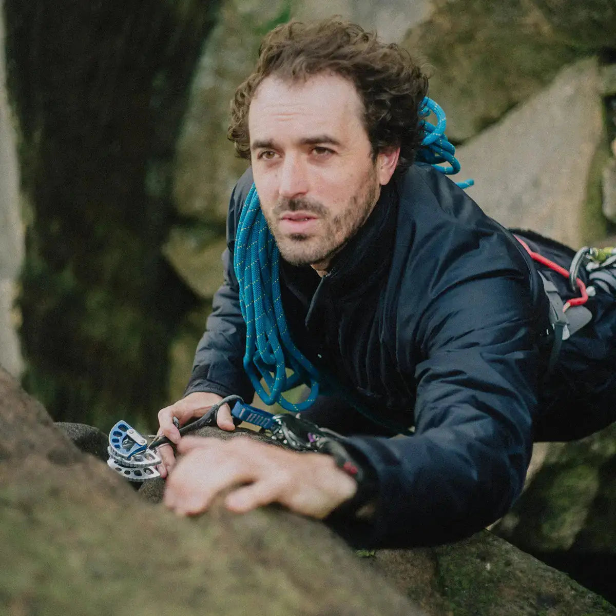 Climber scaling rocks in Buffalo Mens Pertex Belay Jacket, demonstrating its technical design and performance in extreme conditions.  from  John Bull Clothing 