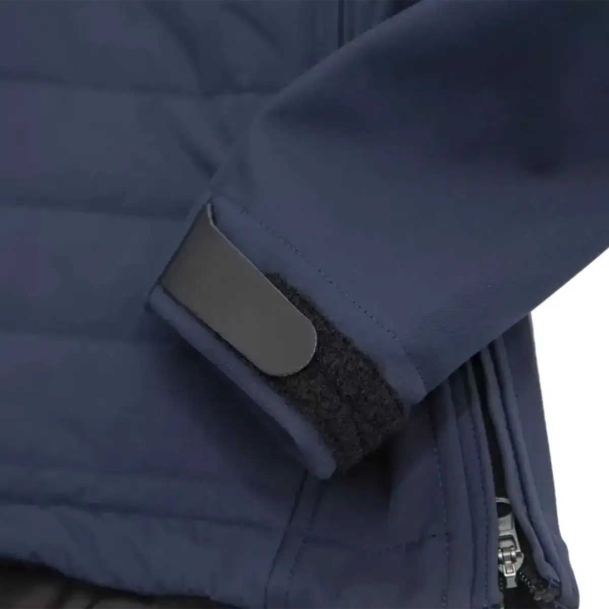 Detail of sleeve cuff with Velcro strap and reflective patch on navy blue Carinthia G-Loft ISG PRO jacket for adjustable fit  from  John Bull Clothing 