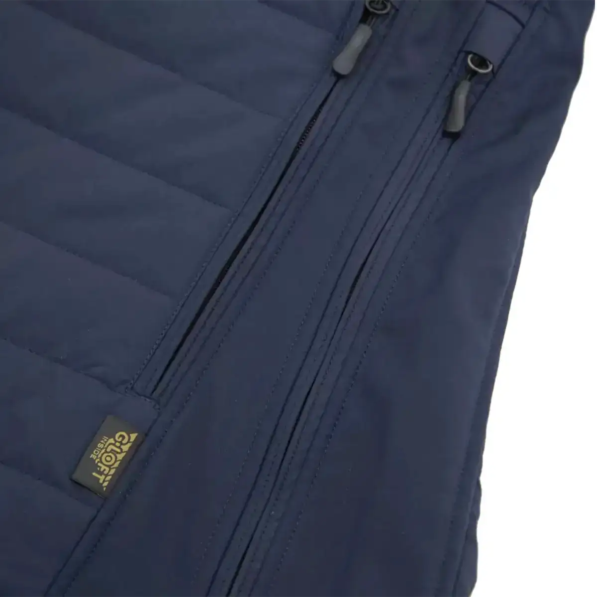 Close-up of waterproof zipper on navy blue Carinthia G-Loft ISG PRO jacket, showing detailed stitching and high-quality material  from  John Bull Clothing 