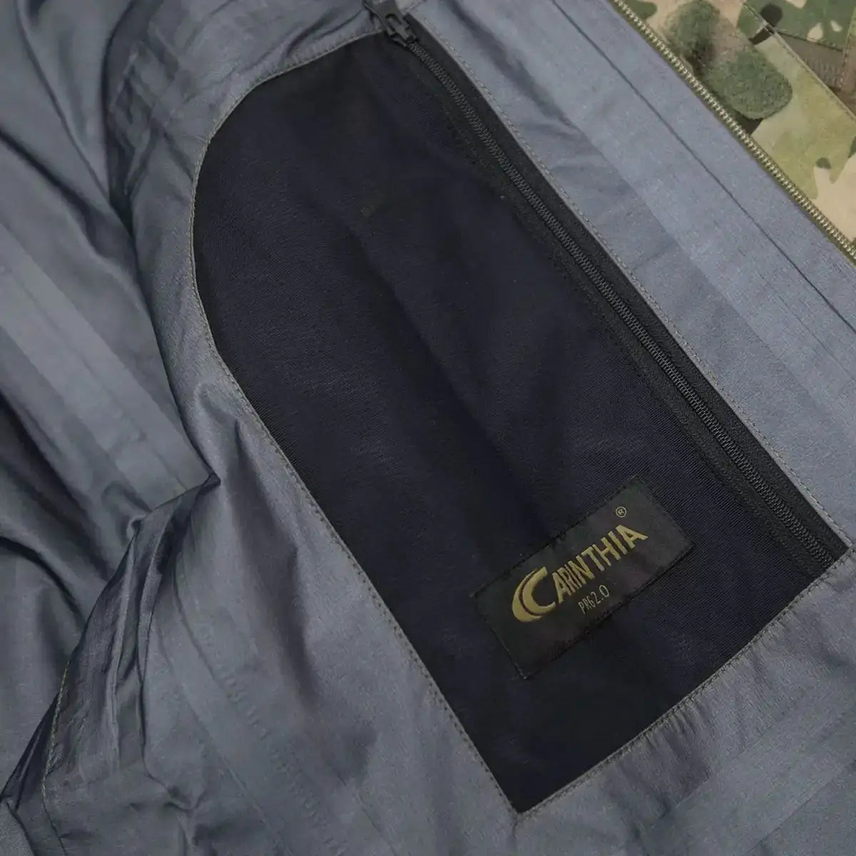 Interior pocket detail of Carinthia PRG 2.0 Waterproof Jacket Multicam with branded label and zippered storage compartment.  from  John Bull Clothing 