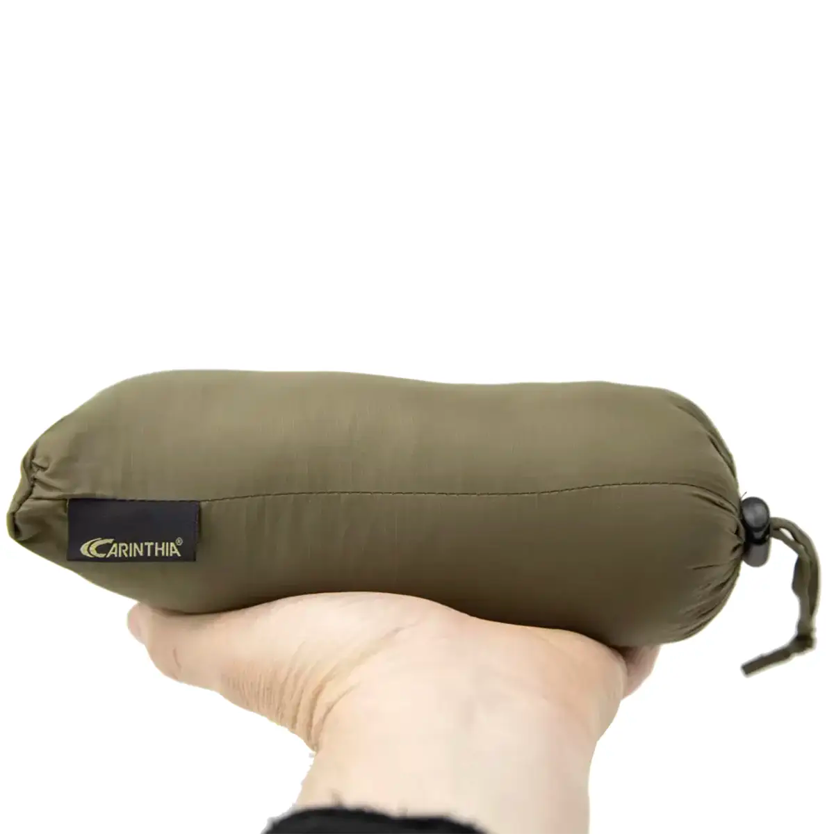Olive green Carinthia travel pillow with black logo, compact size, soft fabric, ideal for camping and outdoor travel, SKU: JB1629-OG