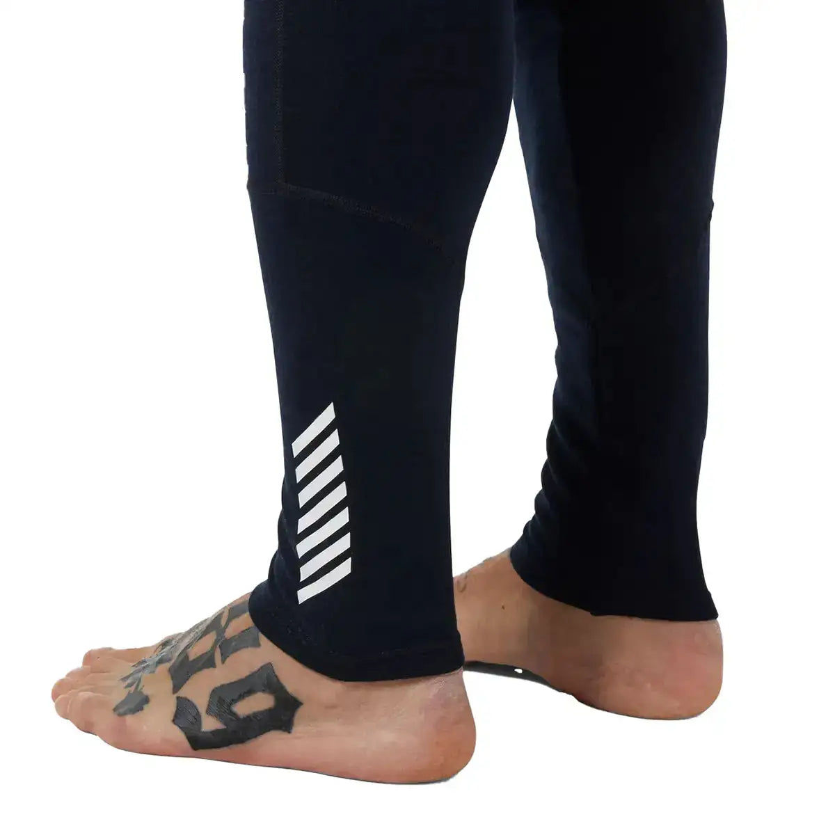 Black Helly Hansen Lifa Merino Midweight Base Layer Trousers with white stripe design on leg, made of thermal material, close-up of lower body  from  John Bull Clothing 