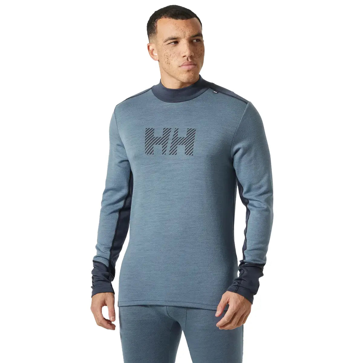 Helly Hansen Lifa Midweight Logo Merino Base Layer in blue worn by male model, showcasing front design and athletic fit for activewear use.