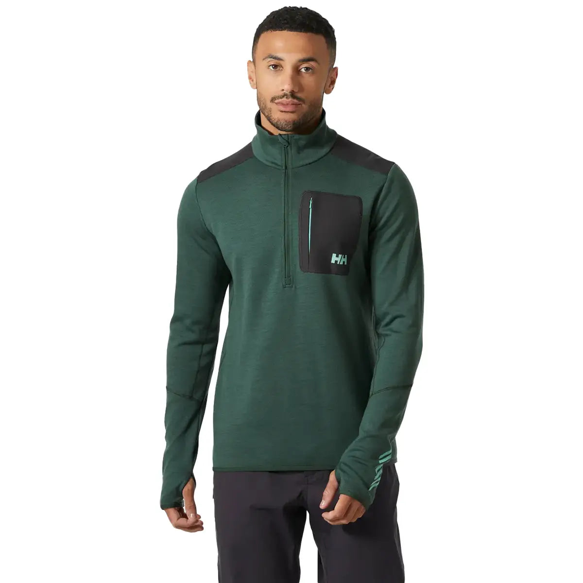 Helly Hansen Lifa Merino Wool Mid Layer 1/2 Zip in green worn by male model, featuring chest zip pocket and thumbholes for activewear layering.