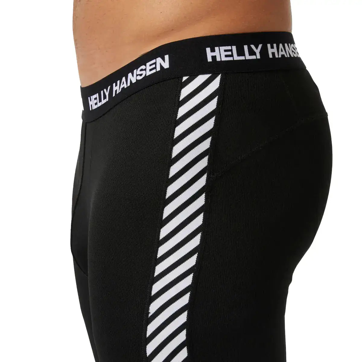 Close-up of the black Helly Hansen men's base layer trousers waistband with white Helly Hansen logo, made of elastic material for a snug fit.  from  John Bull Clothing 