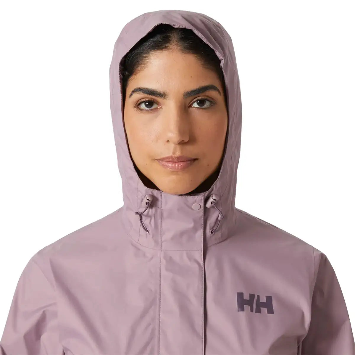 Close-up of model wearing hooded Helly Hansen Womans Loke 2.0 Waterproof Jacket, emphasizing face coverage and collar design.  from  John Bull Clothing 