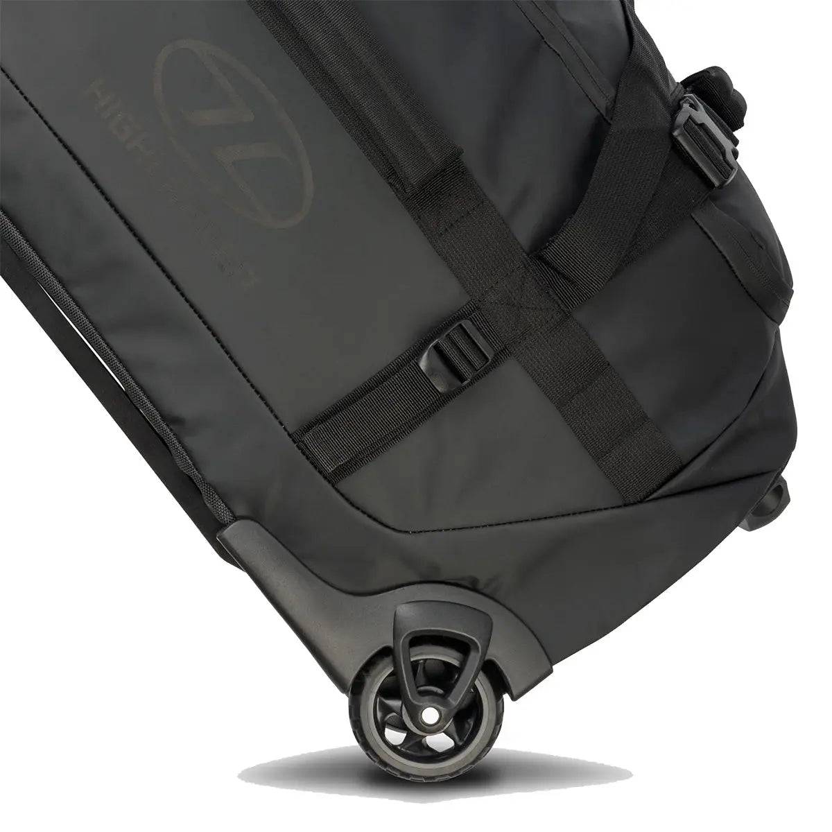 Close-up of the Highlander The Trailer 100 Litre Duffel Bag Black, showcasing its durable wheels and reinforced straps for easy transport.
