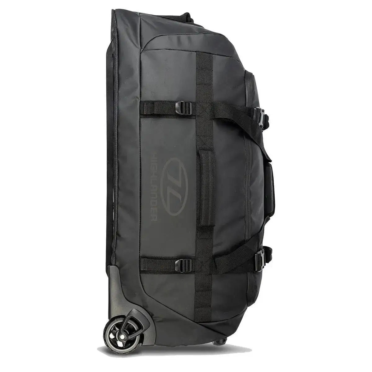 Highlander The Trailer 100 Litre Duffel Bag Black standing upright, featuring heavy-duty straps, robust wheels, and a water-resistant design.  from  John Bull Clothing 