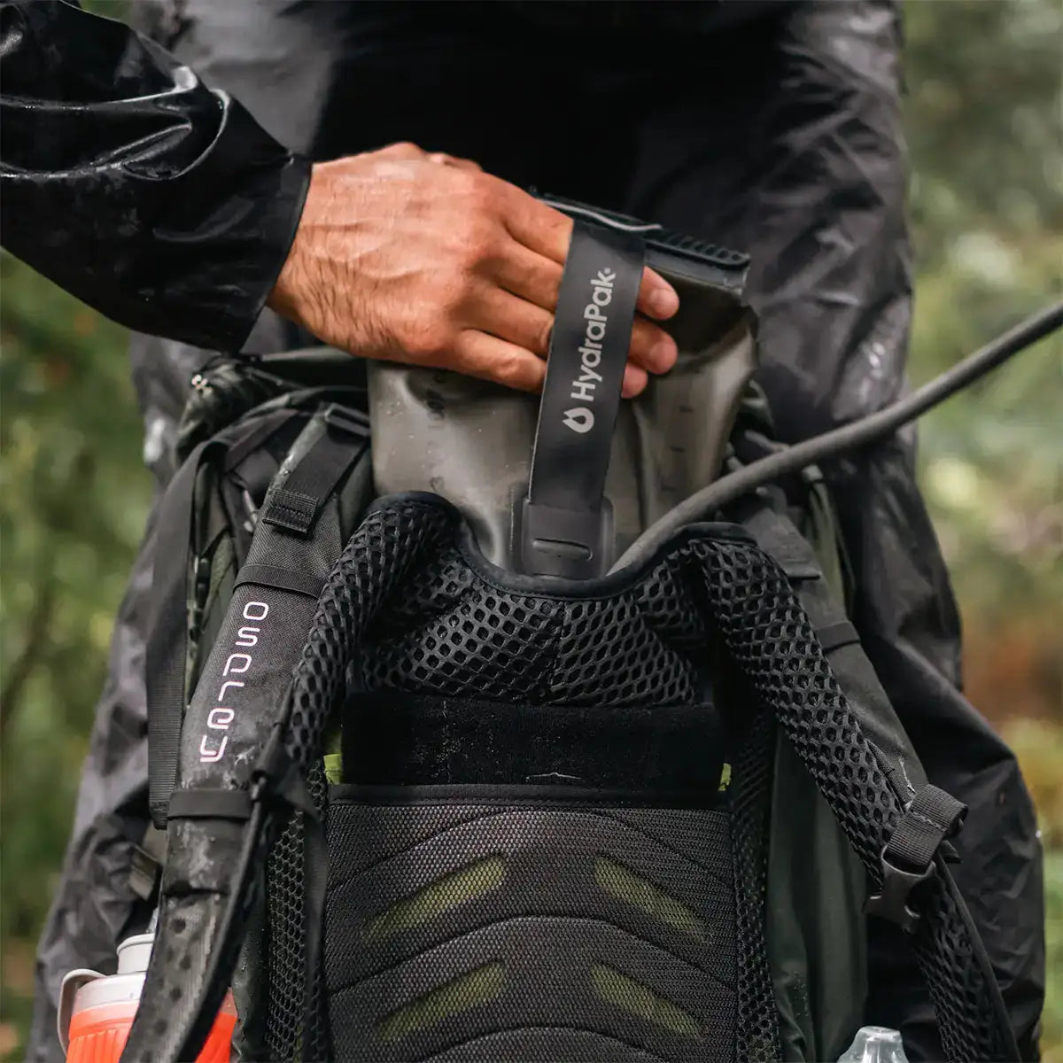 User inserting HydraPak Force Tactical Grey Water Reservoir into hiking backpack, built for extreme outdoor conditions | John Bulls  from  John Bull Clothing 