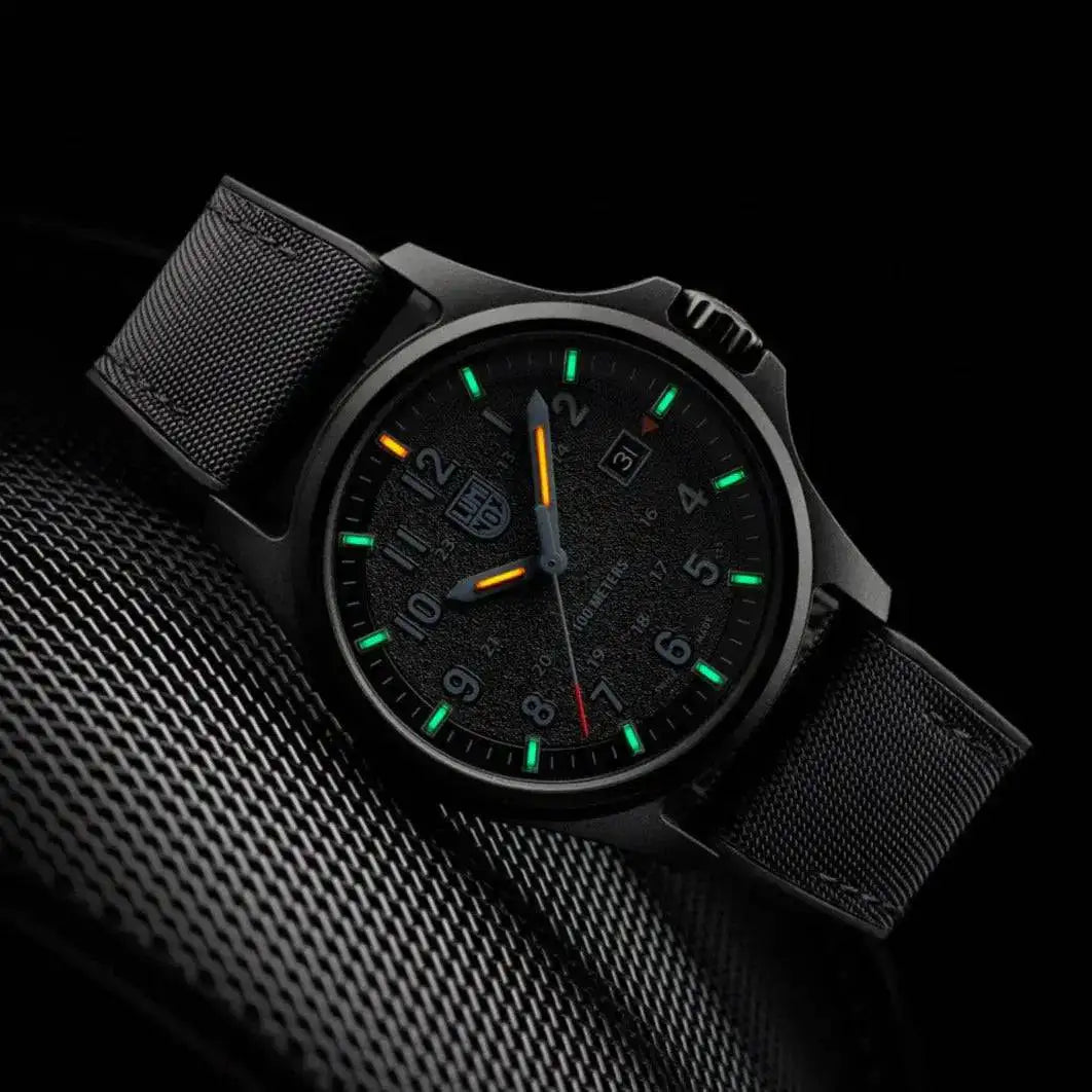 Luminox Atacama Field 1960 Series Watch Black 43mm XL.1961 in a dark setting, showcasing its glowing green and orange self-powered illumination.  from  John Bull Clothing 