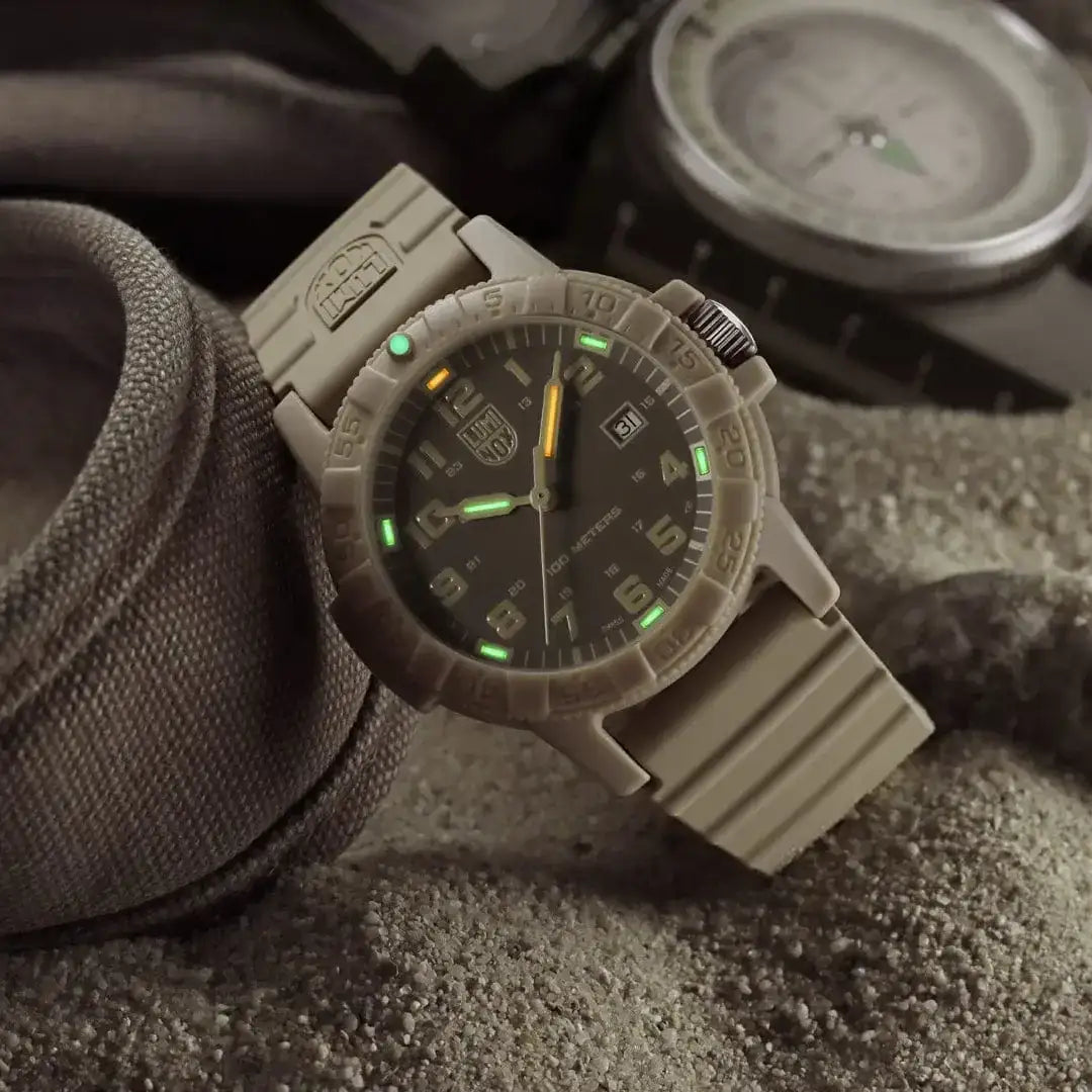 Luminox beige tactical watch worn on wrist, featuring luminous hands, markers, date display, and durable resin strap, glow in dark.