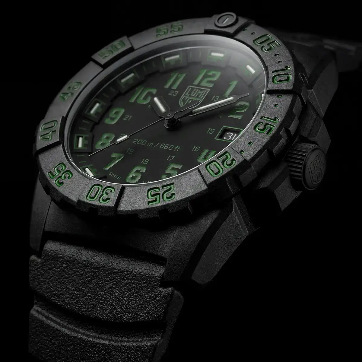 Wrist shot of black Luminox Navy Seal 44mm watch with green luminous dial, rugged strap, and luminous hands for low-light visibility