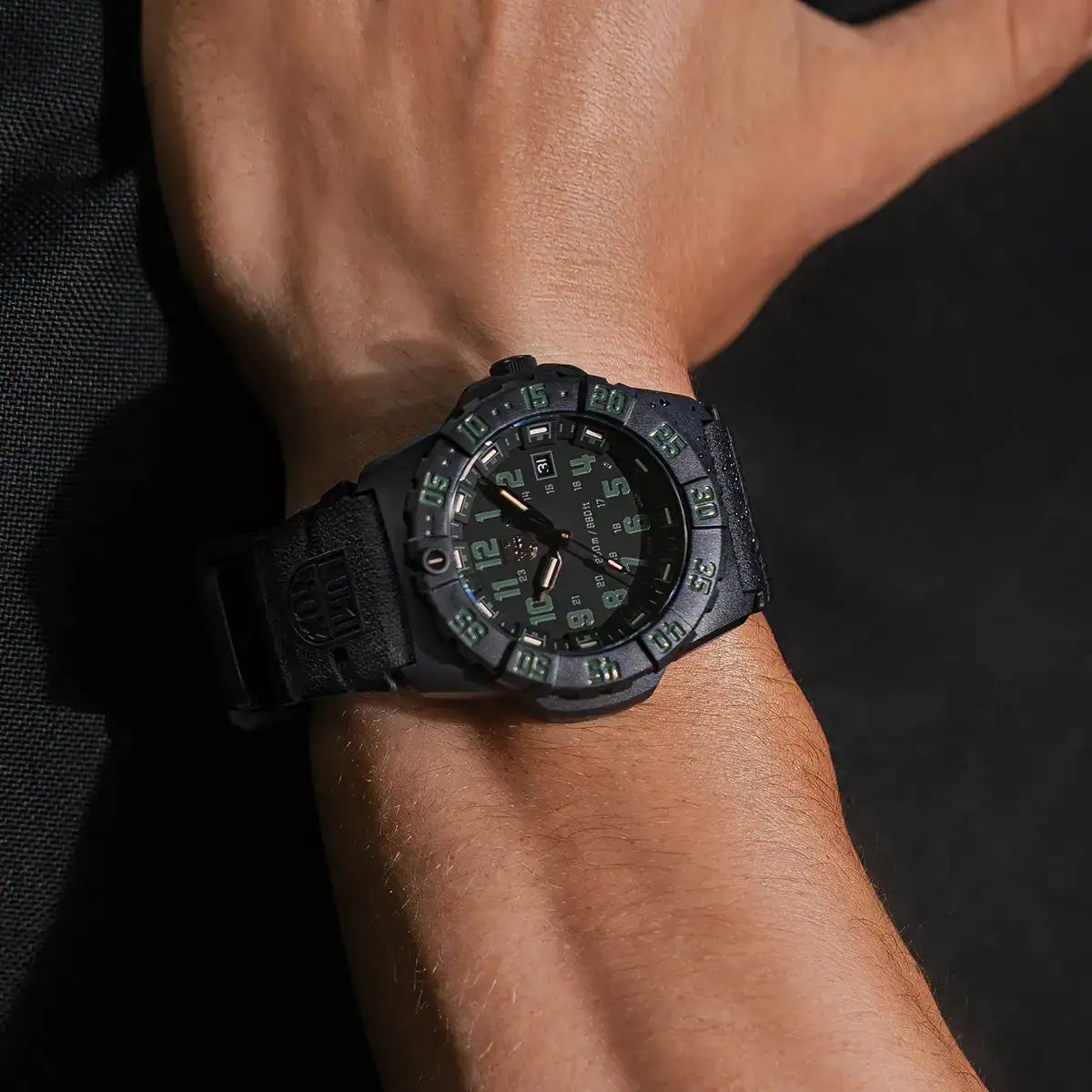 Black Luminox Navy Seal 44mm diver watch on wrist with green luminous markers, durable rubber strap, and military-inspired design