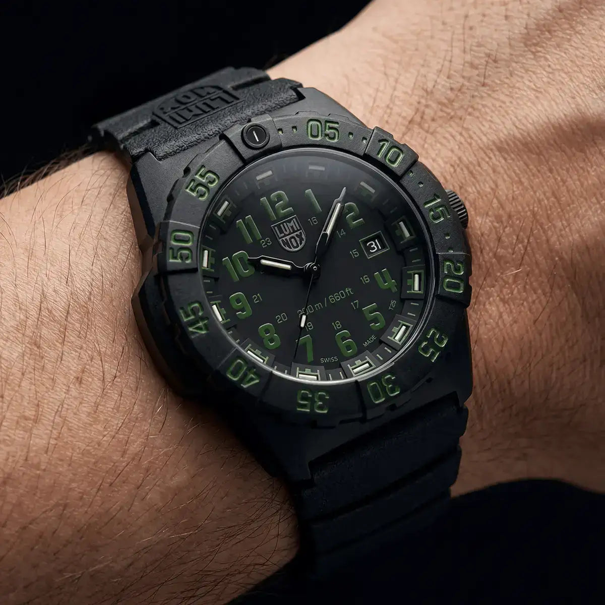 Black Luminox Navy Seal 44mm diver watch with green luminous numerals and markers, black rubber strap, date display, and unidirectional bezel on wrist