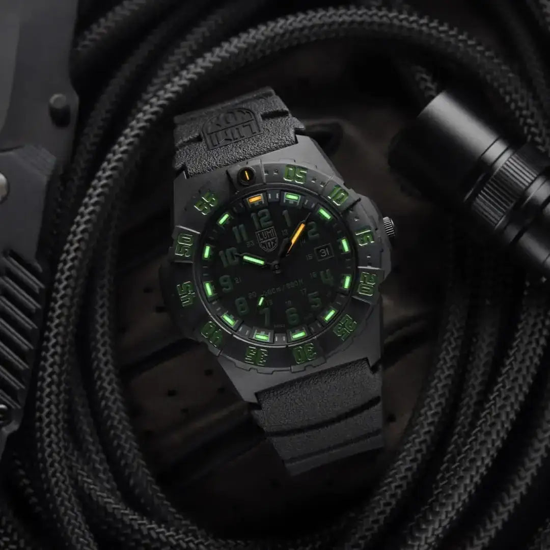 Close-up of black Luminox Navy Seal 44mm watch with luminous green markers, rugged case, and official U.S. Navy typeface