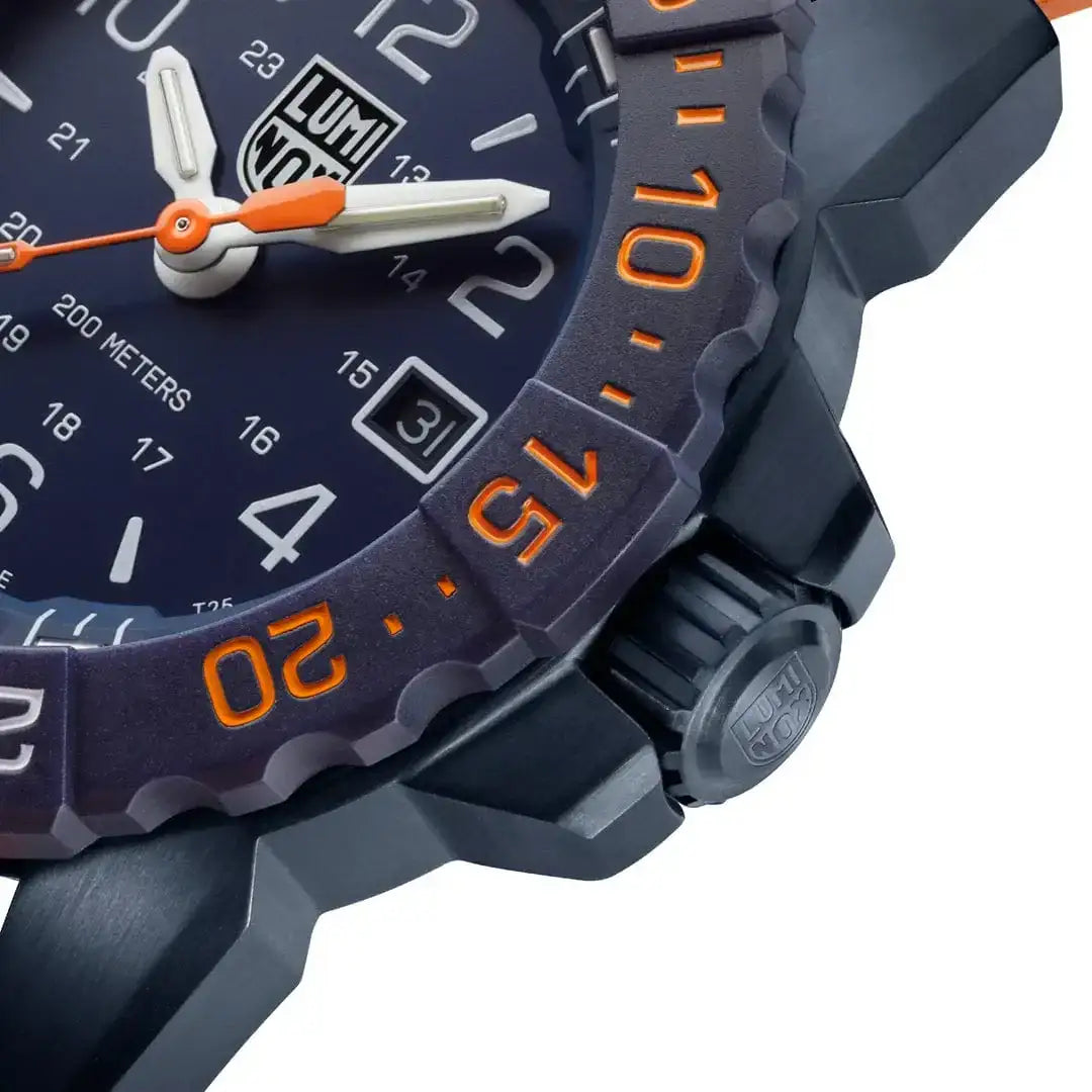 Close-up of Luminox Navy Seal Foundation Back to Blue military watch with navy blue carbonox case, orange bezel, and white luminous hands