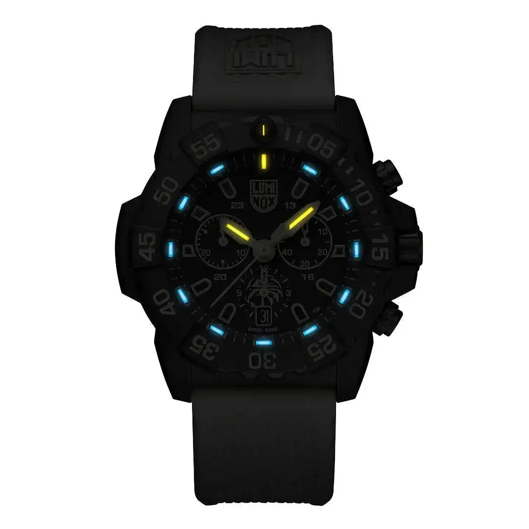 Luminox Navy SEAL Foundation Chronograph Dive Watch glowing in the dark with blue and yellow luminescent markers for enhanced visibility.  from  John Bull Clothing 