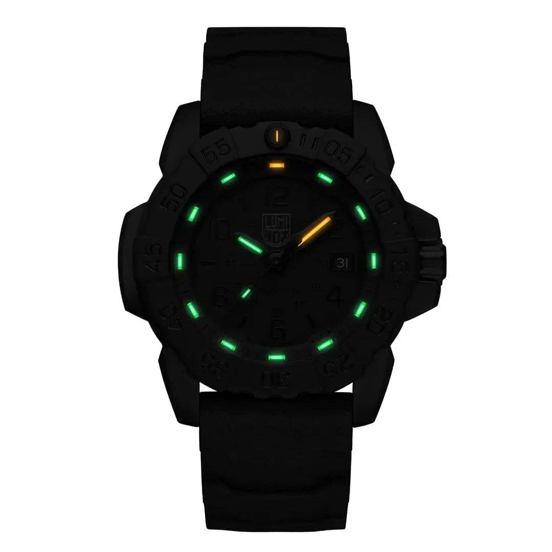 Luminox Navy Seal Steel 3250 Series Black 45mm XS.3251.BO.CB watch in low-light conditions, showcasing its green and orange self-powered illumination.