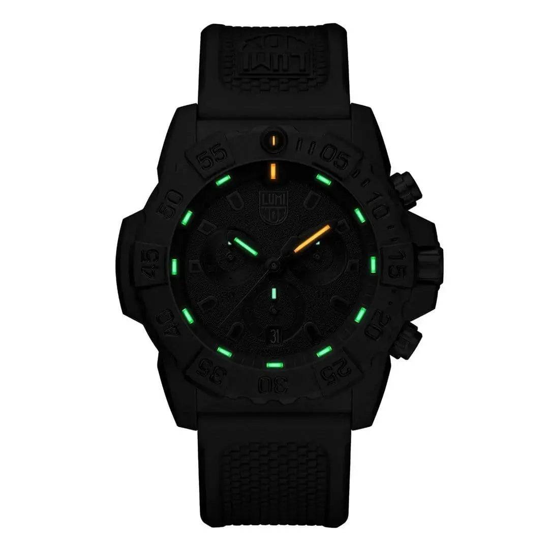 Luminox Navy Seal Steel 3580 Series Chronograph Watch in low-light conditions, showcasing its green and orange luminescent dial markers for visibility.