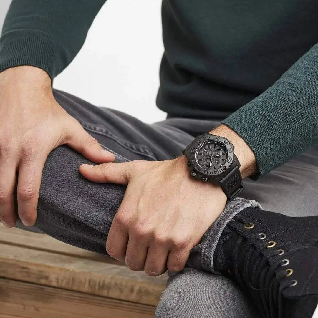 Man wearing the Luminox Navy Seal Steel 3580 Series Chronograph Watch, highlighting its bold black design and tactical appeal for everyday wear.  from  John Bull Clothing 