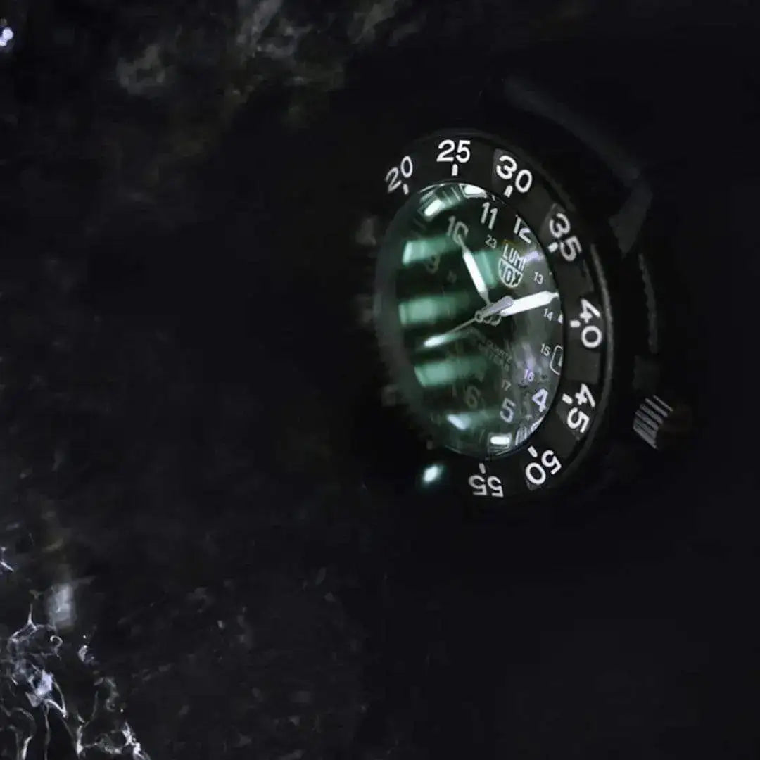 Luminox Navy Seal 3000 Series Diver Watch XS.3001.F glowing underwater, emphasizing its 200-meter water resistance and night visibility.  from  John Bull Clothing 